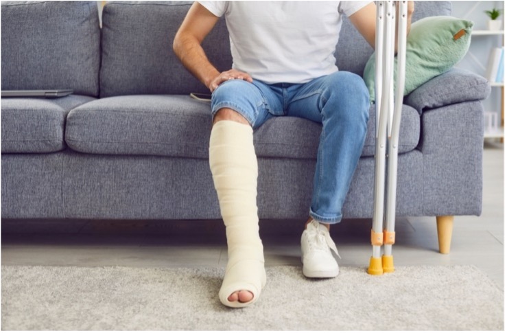 Man sitting with crutches